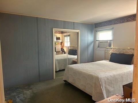 carpeted bedroom with a closet