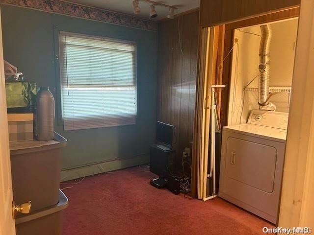 clothes washing area with carpet flooring, track lighting, and washer / dryer