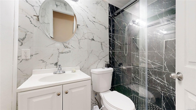 bathroom with an enclosed shower, vanity, toilet, and tile walls