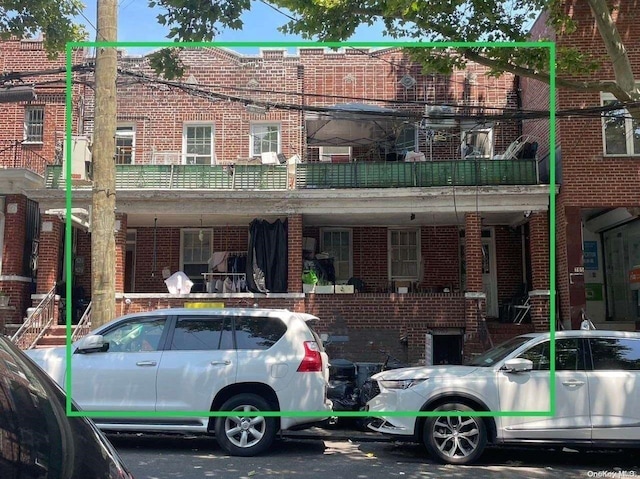 back of property featuring a balcony