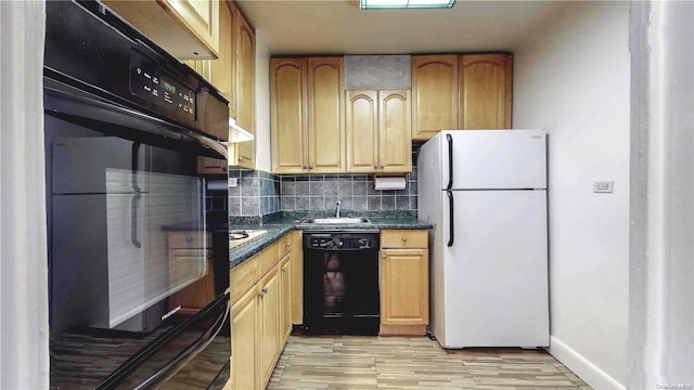 kitchen with black appliances, light hardwood / wood-style floors, sink, and backsplash