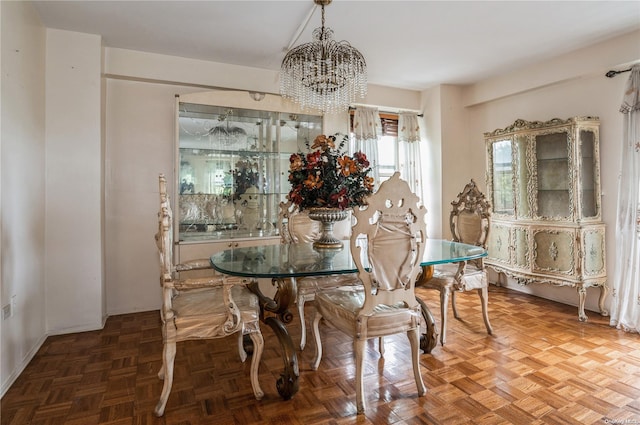 dining room featuring parquet floors and an inviting chandelier