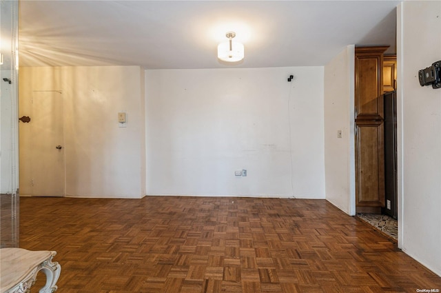 empty room featuring dark parquet flooring