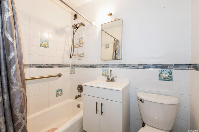 full bathroom with vanity, toilet, tile walls, and shower / tub combo