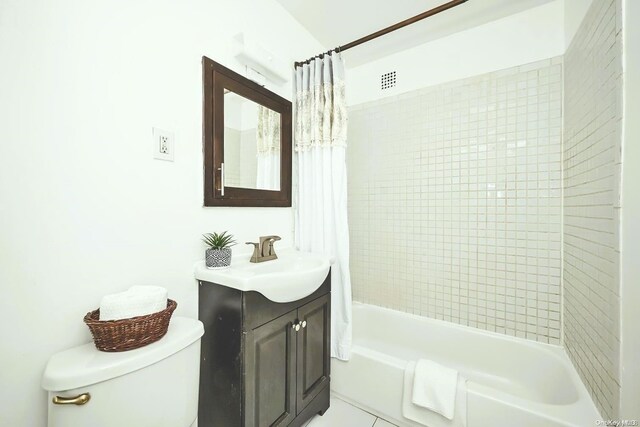 full bathroom with tile patterned floors, vanity, toilet, and shower / tub combo with curtain