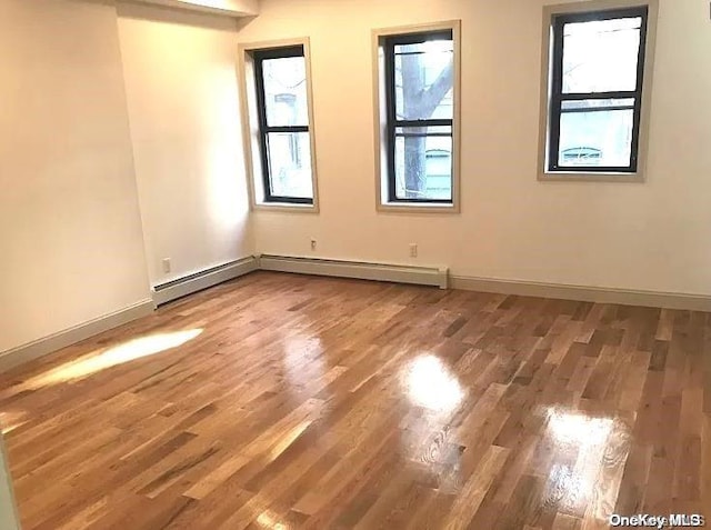 unfurnished room with wood-type flooring