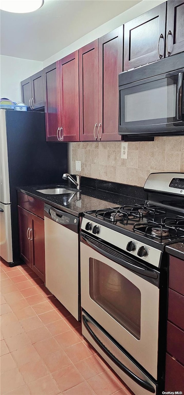 kitchen with backsplash, sink, and appliances with stainless steel finishes