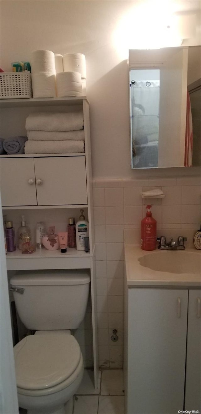 bathroom featuring tile patterned flooring, vanity, and toilet