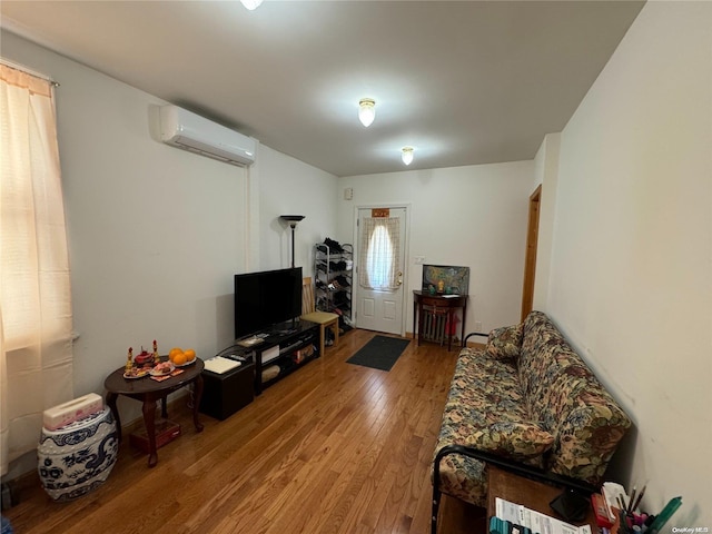 living room with hardwood / wood-style floors and a wall mounted AC