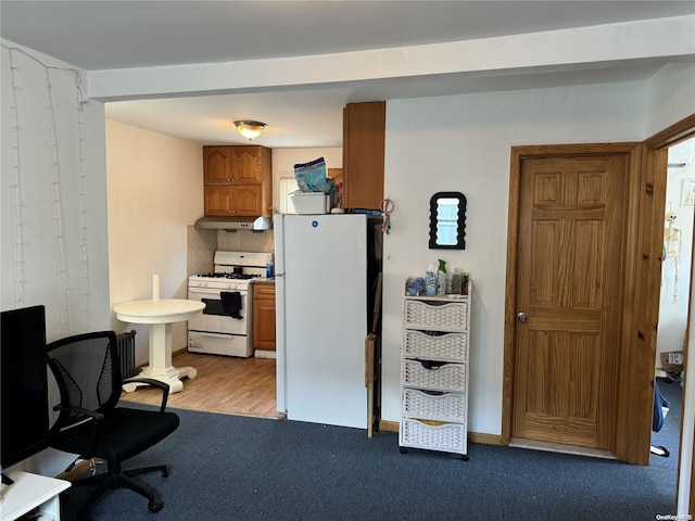 kitchen with white appliances, light hardwood / wood-style floors, and tasteful backsplash