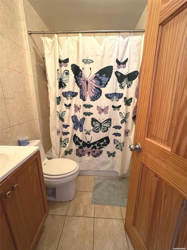 bathroom with tile patterned flooring, vanity, toilet, and a shower with shower curtain