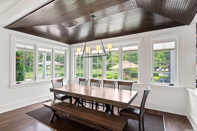 sunroom featuring plenty of natural light, lofted ceiling, and an inviting chandelier