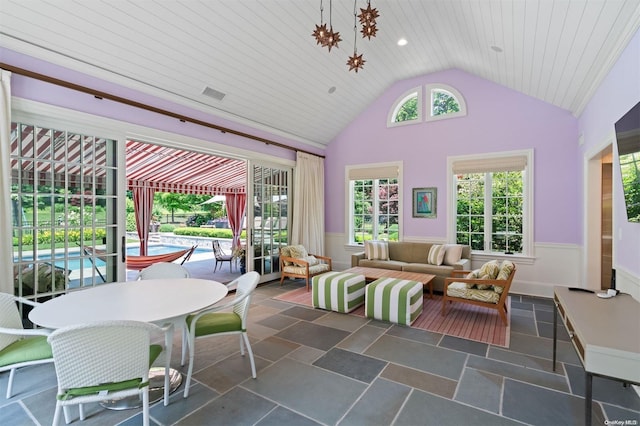 sunroom featuring vaulted ceiling and wood ceiling