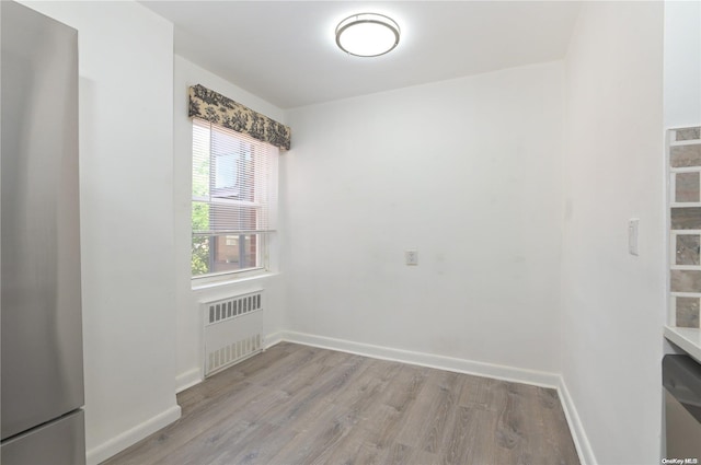 30 Stoner Ave Unit 3R, Great Neck, NY 11021 - empty room featuring radiator heating unit, light wood-style floors, and baseboards