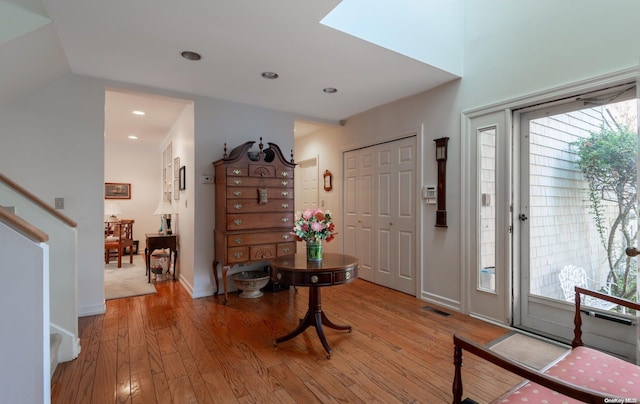 entrance foyer with light hardwood / wood-style floors and lofted ceiling