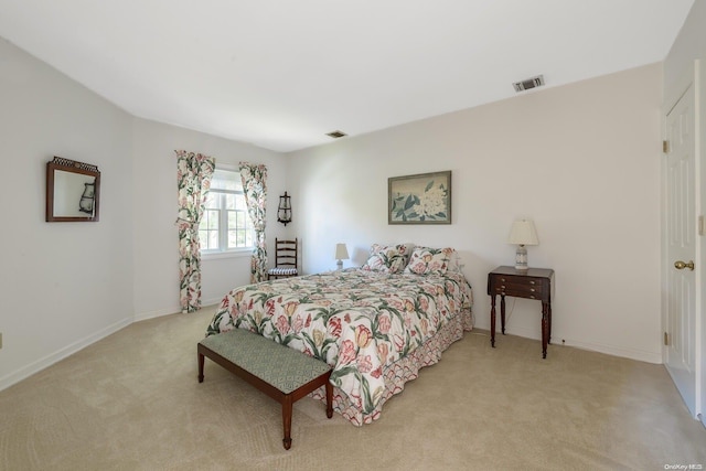 bedroom featuring light carpet