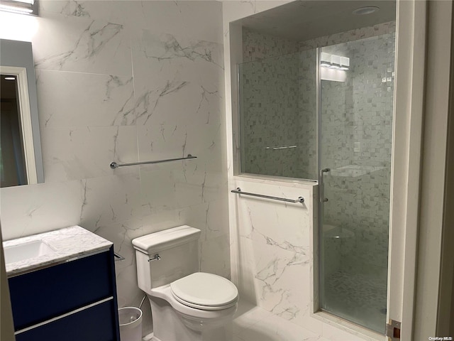 bathroom featuring vanity, toilet, a shower with shower door, and tile walls