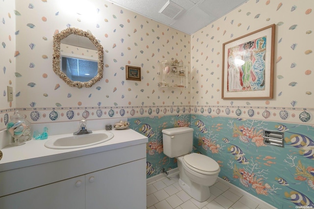 bathroom featuring tile patterned flooring, vanity, and toilet