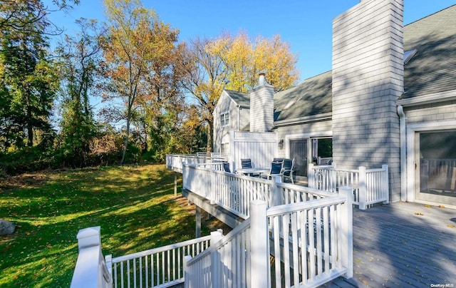 wooden terrace with a lawn