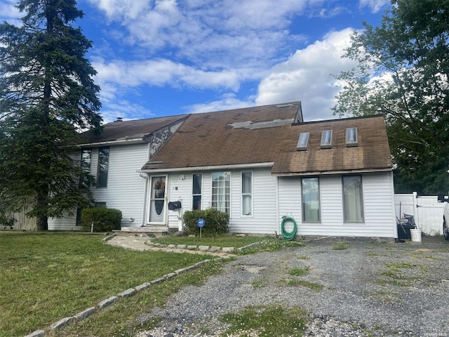 rear view of house with a yard