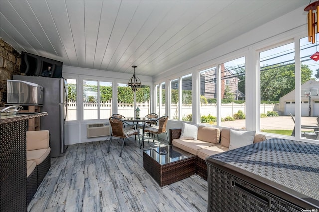 sunroom / solarium featuring a wall mounted air conditioner and wooden ceiling