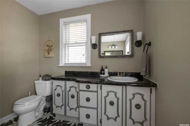 bathroom with tile patterned floors, vanity, and toilet