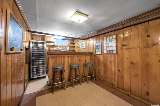 bar featuring wood walls and wine cooler