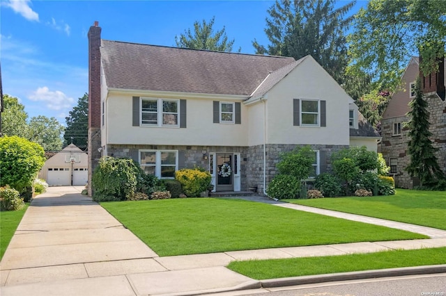 view of front of house featuring a front yard and a garage