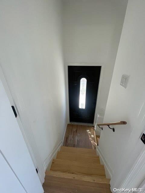 stairs with hardwood / wood-style floors