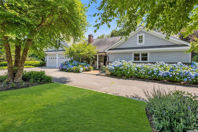 view of front of home with a front yard and a garage