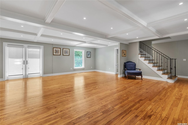 unfurnished living room featuring french doors, beamed ceiling, light hardwood / wood-style floors, and coffered ceiling