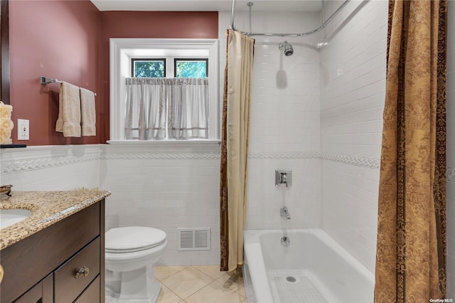 full bathroom featuring tile patterned floors, vanity, toilet, and tile walls