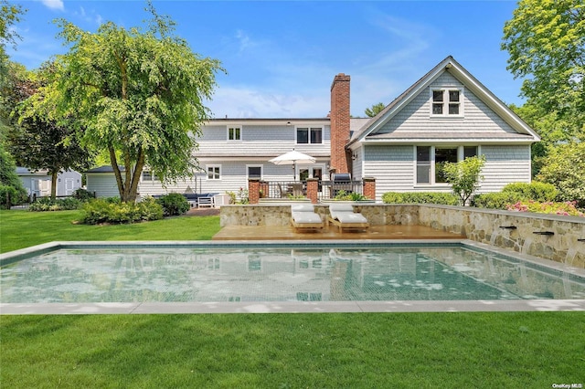 rear view of house with a lawn