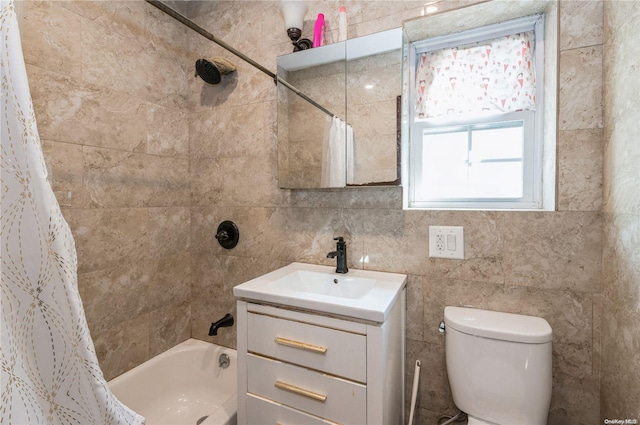 full bathroom with shower / tub combo, vanity, toilet, and tile walls