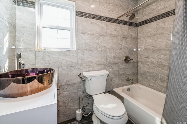 full bathroom featuring vanity, toilet, shower / bathtub combination with curtain, and tile walls