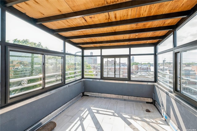 unfurnished sunroom with vaulted ceiling with beams