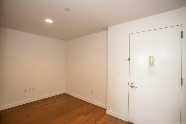 unfurnished room featuring dark hardwood / wood-style floors