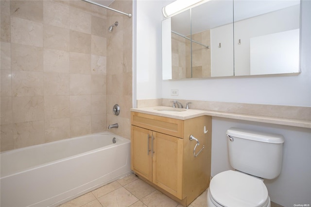 full bathroom featuring tile patterned floors, tiled shower / bath combo, toilet, and vanity