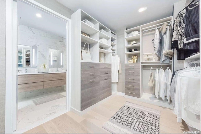 spacious closet featuring light hardwood / wood-style floors