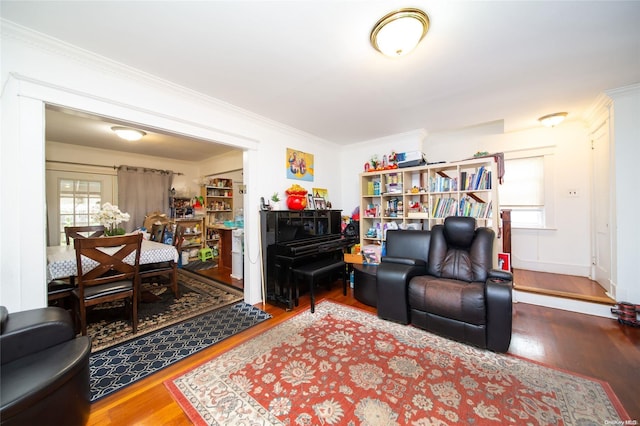 living room featuring wood-type flooring and crown molding