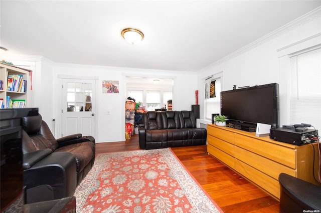 living room featuring wood-type flooring and ornamental molding