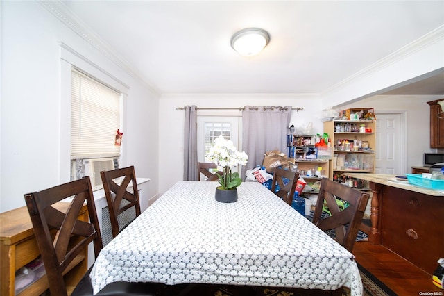 dining room with cooling unit, wood-type flooring, and ornamental molding