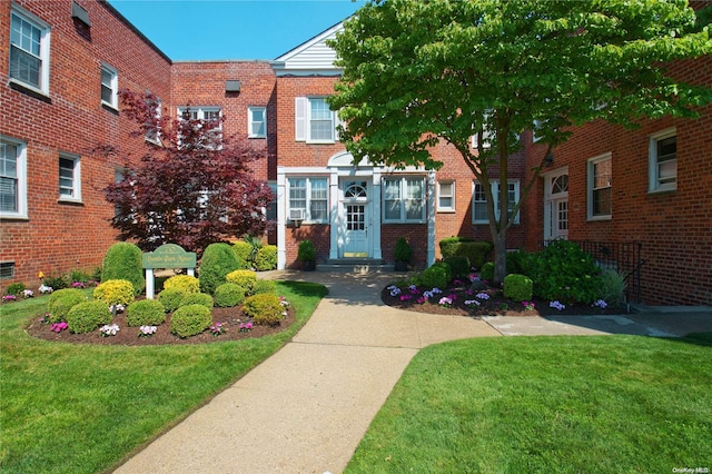 70 S Park Ave Unit 112, Rockville Centre, NY 11570 - view of front of property featuring a front yard and brick siding