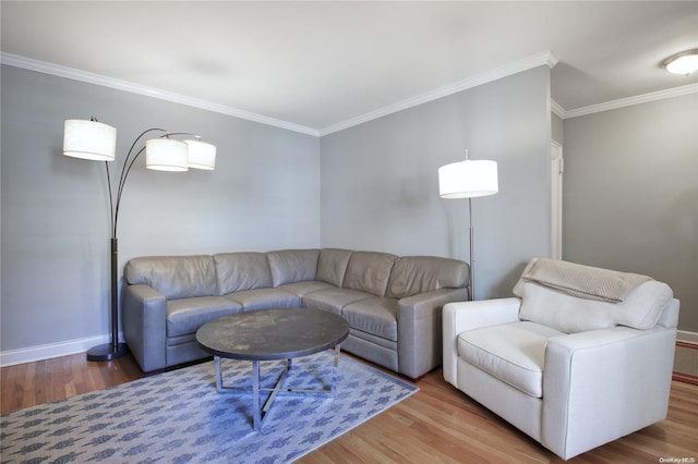 living room with wood-type flooring and ornamental molding