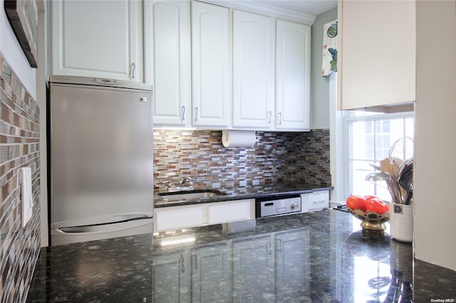 kitchen with sink, white cabinets, dark stone counters, and appliances with stainless steel finishes