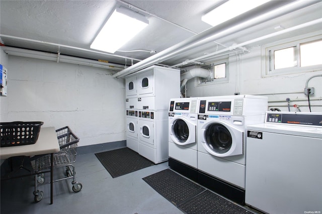 washroom featuring stacked washer / drying machine and washing machine and clothes dryer