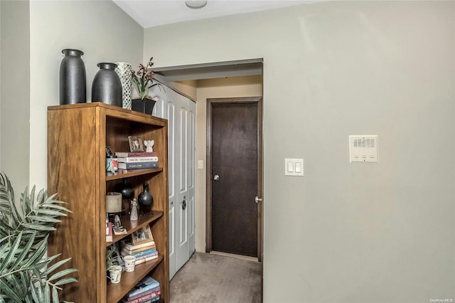 corridor featuring light colored carpet