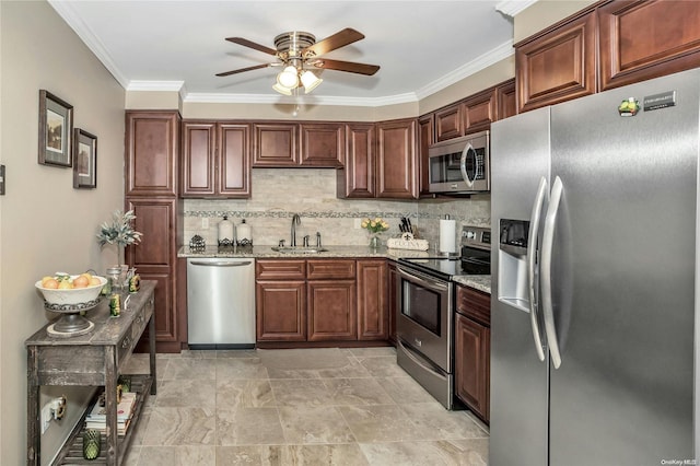 kitchen with light stone counters, sink, appliances with stainless steel finishes, and crown molding