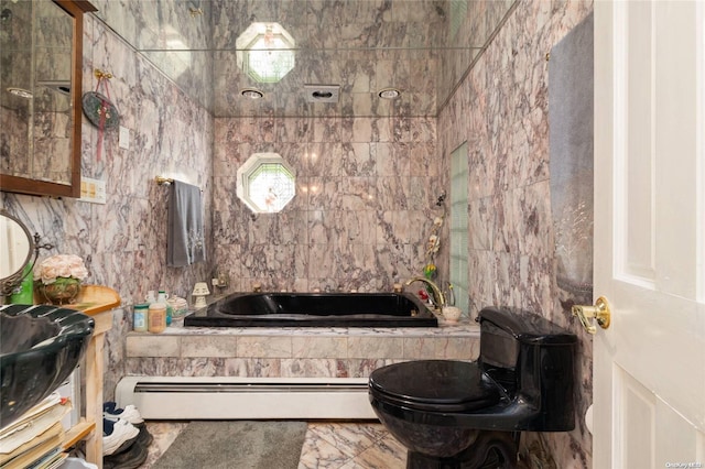 bathroom featuring baseboard heating, tiled bath, tile walls, and toilet