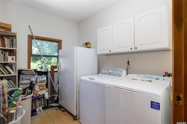 laundry room featuring cabinets and washing machine and clothes dryer